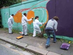 Volunteers painting the community mural. 