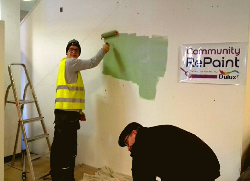 Volunteer painter at Community RePaint Cheshire painting with affordable ReColour emulsion.