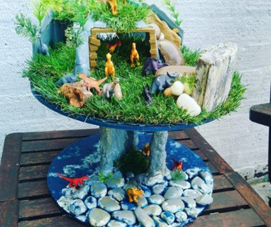 Upcycled cable reel that has been turned into a painted Fairy Garden, using cheap and recycled paint from Community RePaint Coventry.