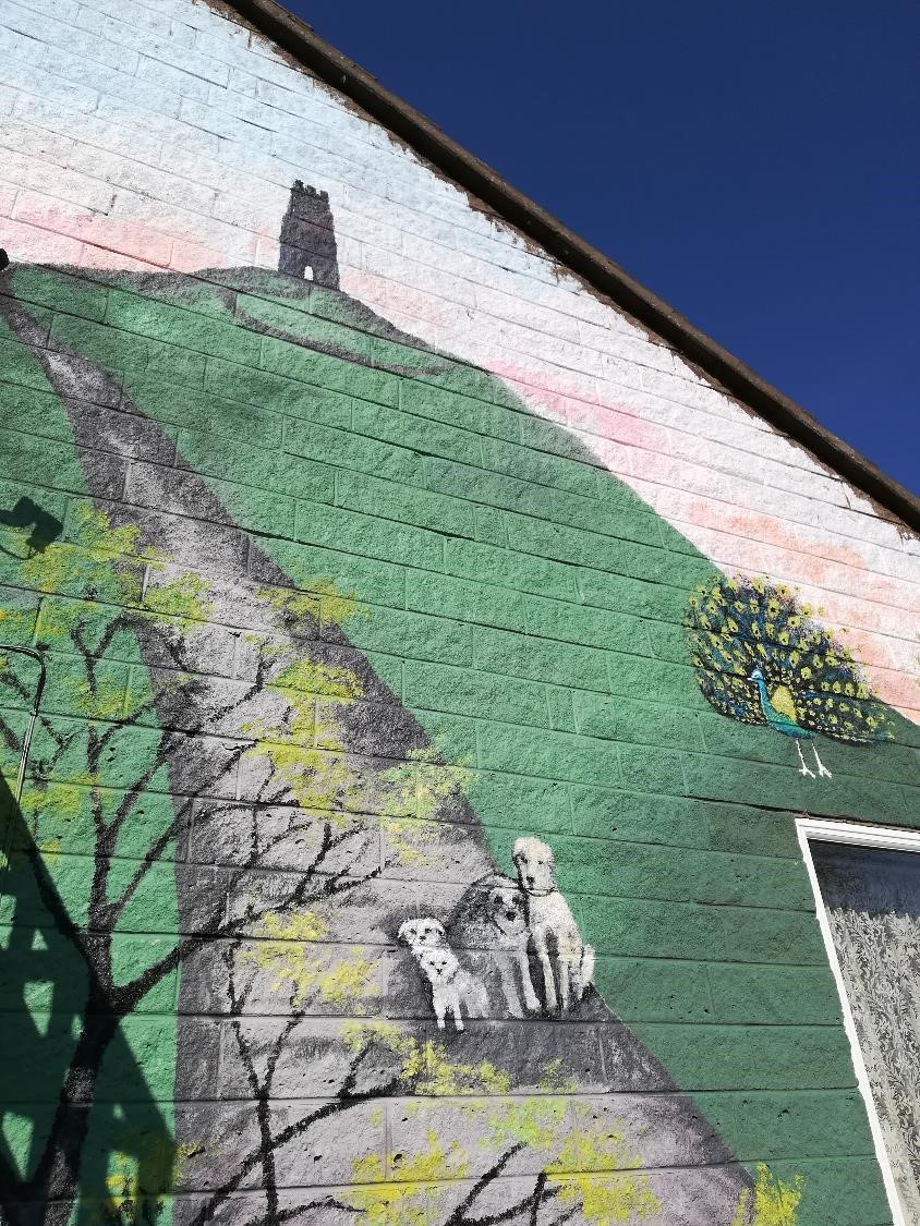 Painted home in Glastonbury featuring a mural of the Glastonbury Tor