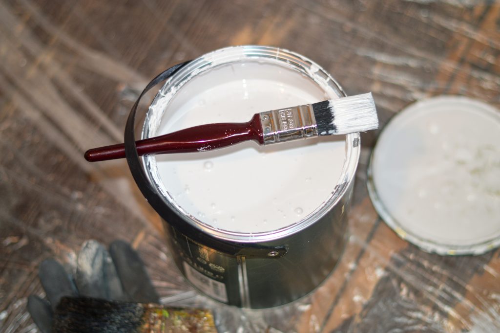 Paint tin being used