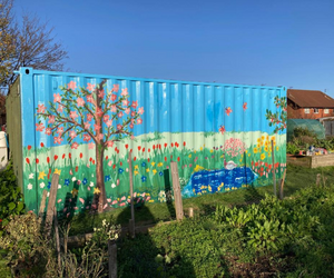 Bright coloured mural on a shipping container at Hull City Centre's allotments