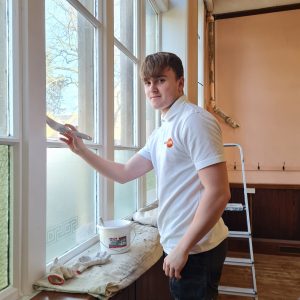 A member of the Trades4Care team working to redecorate Barnard Castle Methodist church hall
